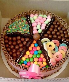 a box filled with lots of different types of candies and chocolates on top of each other