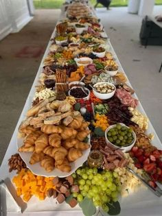 a long table filled with lots of different foods and snacks on it's sides