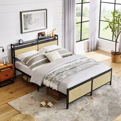 a bed sitting on top of a wooden floor next to a window