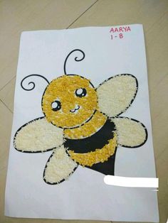 a drawing of a smiling bee on a piece of paper