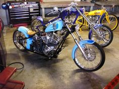 three motorcycles parked in a garage next to each other