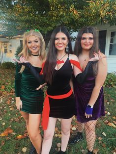 three women dressed in costumes posing for the camera