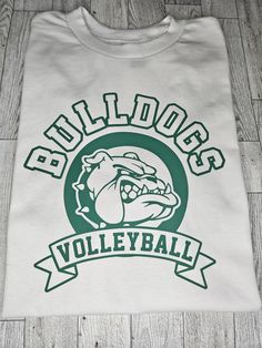 a white t - shirt with green lettering on the front that says bulldogs volleyball