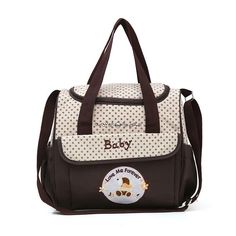 a brown and white baby bag with polka dots on it's side, featuring an image of a dog