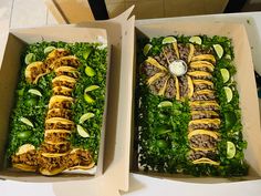 two boxes filled with food sitting on top of a table