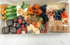 a box filled with assorted fruits and veggies on top of a table