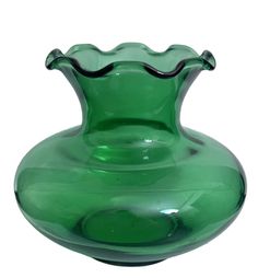 a green glass vase sitting on top of a table