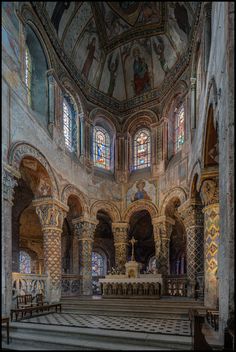 the interior of an old church with stained glass windows