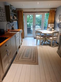 an open kitchen and dining room area with sliding glass doors to the outside decking