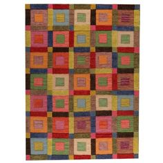 a multicolored rug with squares and rectangles on the bottom in various colors