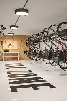 there are many bikes hanging on the wall