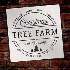 a sign on the side of a brick wall that says christmas tree farm cut and carry