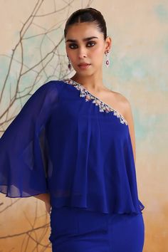 Blue one shoulder jumpsuit with resham embroidered floral motifs, embellished by sequins,beads, applique and crystals. - Aza Fashions One Shoulder Sequin Evening Sets, One Shoulder Georgette Set For Party, One Shoulder Embellished Designer Dress, One Shoulder Embroidered Party Set, One-shoulder Embroidered Party Set, One-shoulder Sequin Set For Party, Elegant One-shoulder Party Sets, One Shoulder Embellished Designer Wear Sets, One Shoulder Sequin Set For Party