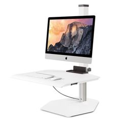 an apple computer sitting on top of a white desk