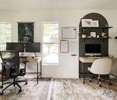 an office with two computer desks and a chair