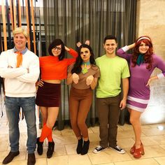 four people dressed up in costumes posing for the camera