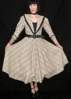 "Vintage 1940's Style Rainbow Black White Striped Avant Garde Fit and Flare Dress by \"Foxy Lady - San Francisco!\" Features: - an eye-catching black, white, and pastel rainbow striped print - edgy, dramatic pointed collar, with black cotton underside - pleating at tops of sleeves to create dramatic puff shoulders and sleeves - sleeves are a 3/4 length with upturned, split, winged cuffs with a decorative black button - bodice can be worn tight, or bloused, depending on your measurement - nipped Retro Striped Lined Dress, Vintage White Top With Striped Collar, Victorian Dress Stripes, Vintage Collared Top With Vertical Stripes, Black And White Stripe 50s Dress, New Look Fashion, Cocktail Party Dress, Wiggle Dress, 1940s Fashion