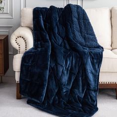 a large blue blanket sitting on top of a couch