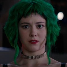 a woman with green hair wearing a choker