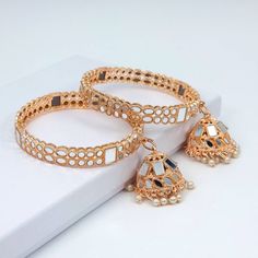 Lightweight Rose Gold Mirror Stone Diamond CZ Bangles with Latkan Jhumki. Pair of Bangles. Color Gold and size Available:  Size: 2.6 and 2.8 Rose gold base filled with antique Mirror stones and pearl work droplets. We try to take photos as naturally as we can, but colour can be slightly varied due to lighting. Jewelry Care -- Keep all the jewelry away from water, perfumes, and other harsh chemicals Please note: No Returns No Exchange. But If you have any issue with your order, Kindly contact us before leaving a review. Festive Metal Bracelets With Latkans, Festive Metal Bracelet With Latkans, Festive Rose Gold Chandbali Jewelry, Elegant Chandbali Bangle With Latkans, Rose Gold Jewelry For Festivals And Celebrations, Rose Gold Jewelry For Celebrations And Festivals, Bangles With Latkan, Bangle Outfit, Mirror Bangles