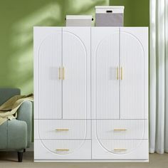 a white armoire with two doors in a living room