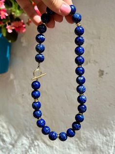 This classic statement necklace was made of huge (14 mm) natural lapis lazuli beads of the top quality. Striking blue color looks very refined and elegant and is complimented with modern gold details.   * Necklace length is 47 cm (18,5 inches) - please contact me if you need any adjustments.   * All metal parts are gold vermeil - silver with a thick layer of gold.    * Necklace comes in a gift box. It will be a great gift idea for a woman on any occasion.   * Handmade in Spain, shipment worldwid Lapis Lazuli Necklace, Lapis Lazuli Beads, Necklace Statement, Necklaces For Women, Beaded Necklaces, Necklace Gift, Gold Details, Necklace Length, Lapis Lazuli