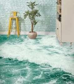 a room with green water and white bricks on the wall next to a yellow chair