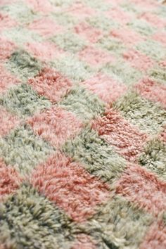 a pink and green rug on the floor