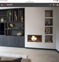 a living room filled with furniture and a fire place next to a wall mounted tv