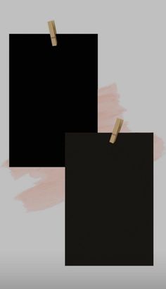 two black square pictures hanging from clothes pins on a pink and gray background with some paint smudges