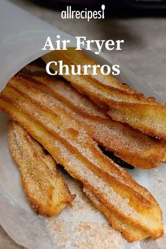 air fryer churros on a plate with powdered sugar in the middle