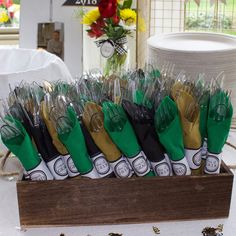 a wooden box filled with lots of different types of scissors on top of a table