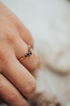 a close up of a person's hand with a ring on their finger,