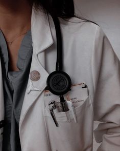 a woman wearing a white coat with a black stethoscope in her pocket