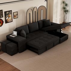 a living room with a black couch and ottoman