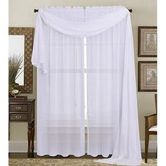 a white sheer curtain hanging from the side of a window