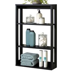 three tiered shelf unit with towels, soaps and other items