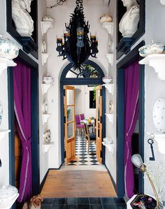 the hallway is decorated in black and white with purple drapes