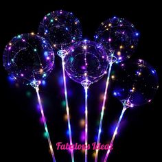 some clear balloons with lights on them in front of a black background and the words fabulous new year written below it