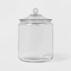 a clear glass jar with a lid on a white background, it appears to be empty