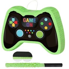 an electronic game controller with a brush on the front and green handle next to it