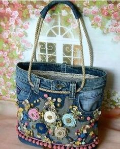 a handbag made out of jeans with flowers on it