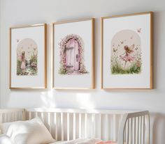 three framed pictures hang on the wall above a crib