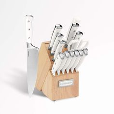 a wooden block with knives in it on a white background