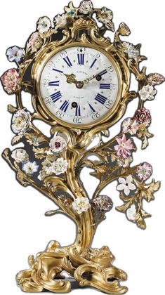 an ornate gold clock with flowers on it