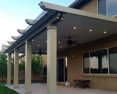 an outdoor covered patio with ceiling fans