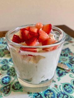 a dessert in a glass with strawberries on top