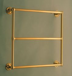 an old fashioned brass towel rack on the wall