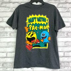 New To Poshmark? Use Code Happyoutfit To Save $10 On Your First Purchase! Pac-Man Kids / Girls / Boys Dark Gray Can’t Catch Pac-Man T-Shirt. ** Pictures Were Taken With Size Medium But There’s Other Sizes Available ** Sizes: Xs (4/5), M (8), L (10/12), Xl (14/16) Condition: New With Tags T Shirt Sayings, Burberry Shirt, Puma Shirts, Shirt Sayings, Pac Man, Vintage Mid Century Modern, Candy Bars, T Shirts With Sayings, Nike Shirts