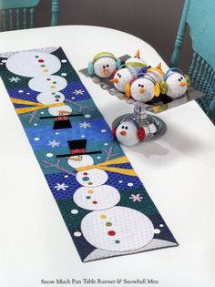 a table runner with snowmen on it